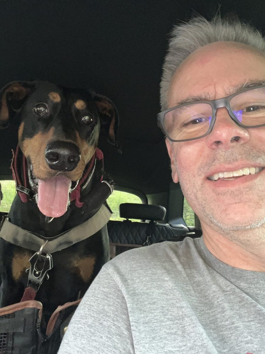 Phil and Ernie together in the car, both smiling